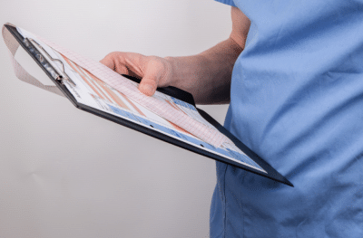 doctor in blue scrubs examining a colorful medical chart-representing-direct-primary-care